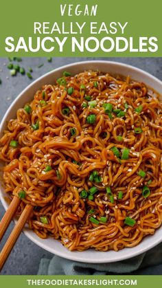 a bowl full of noodles with chopsticks in it and text overlay that reads vegan really easy saucy noodles