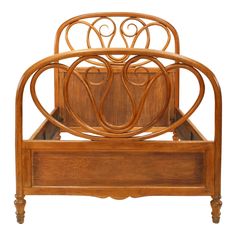 a wooden bed frame with an intricate design on the headboard and foot board,