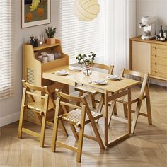 a dining room table and chairs in front of a window