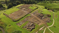 an aerial view of the ancient city of machteridgen in england, with green fields and trees surrounding it