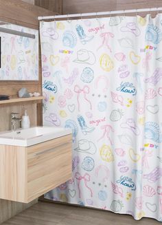 a bathroom with a sink, mirror and shower curtain that has mermaid drawings on it