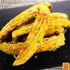 grilled corn on the cob with parsley and chili oil, ready to eat