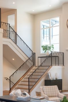 a living room filled with furniture and a stair case