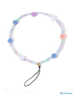 a bracelet with flowers on it and a black string hanging from the end, against a white background