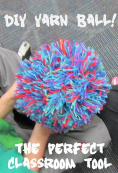 a person sitting on the floor with a colorful ball in their hand and text that reads diy yarn ball the perfect classroom tool