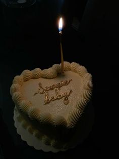 a heart shaped cake with a candle on top