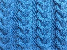 a blue knitted blanket is shown in close up