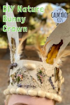 a young boy wearing a paper hat with feathers on it and the words diy nature bunny crown