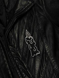 a black leather jacket with a white patch on it