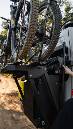 there is a bike on the back of a truck with it's wheels up