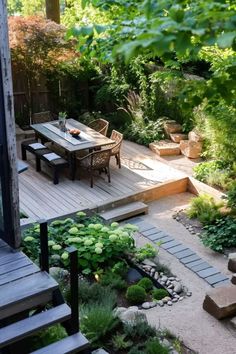 an outdoor dining area in the middle of a garden with steps leading up to it