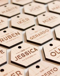 many wooden tags with names on them are arranged in the shape of hexagons