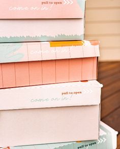 several boxes stacked on top of each other with writing on the lids and bottom half