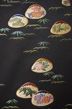 an embroidered fabric with flowers and leaves on it