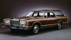 an old station wagon parked in front of two lights on a dark background with the door open