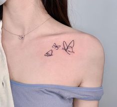 a woman with a small tattoo on her shoulder