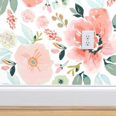 the light switch is on in front of a floral wallpaper with pink and green flowers