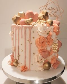 a birthday cake decorated with pink and gold decorations