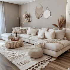 a living room filled with lots of white furniture and decor on top of a wooden floor