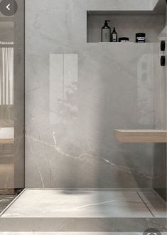 a modern bathroom with marble walls and floor