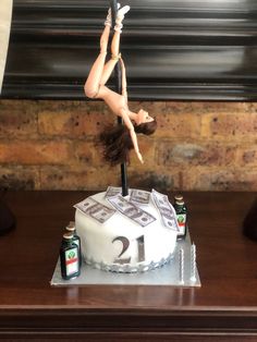 a woman is suspended upside down on top of a cake with money and beer bottles