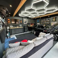 a living room filled with furniture and a car in the garage next to an entertainment center