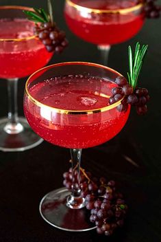 two glasses filled with red wine and garnish