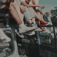 several people sitting on the back of a vehicle