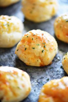 freshly made biscuits with cheese and herbs on a baking sheet