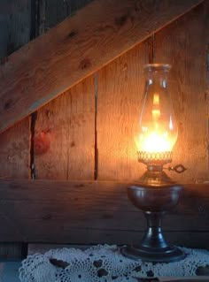 a light that is on top of a table next to a doily and other items