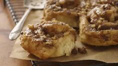 some type of pastry sitting on top of a piece of paper next to a fork