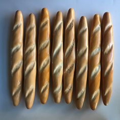 five long breads are lined up in a row