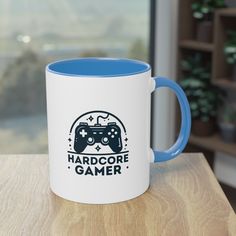 a blue and white coffee mug sitting on top of a wooden table