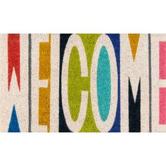 a welcome mat with the word welcome written in multicolored letters on top of it