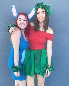 two young women dressed in costumes posing for the camera with their arms around each other