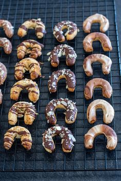 several different types of donuts on a cooling rack