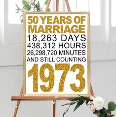 a sign that says 50 years of marriage in gold and white on top of a easel