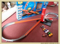 a toy train set is laying on the floor next to other toys and construction equipment