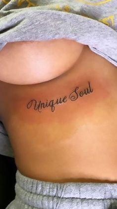 a woman's back with the word unique soul written on it in cursive font