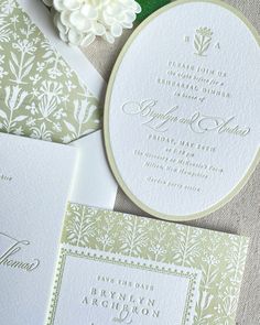 the wedding stationery is laid out on top of each other