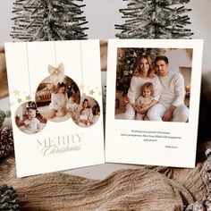 two christmas cards sitting on top of a table