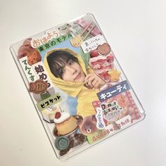 a magazine with an image of a child on the cover and other items around it