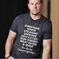 a man wearing a black shirt with words on it