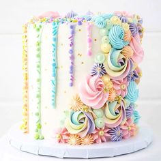 a white cake with multicolored frosting flowers on it