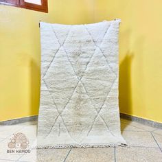 a white rug sitting on top of a tiled floor