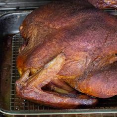 a whole chicken sitting on top of a metal rack