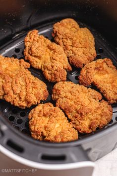 fried chicken in an air fryer basket ready to be cooked