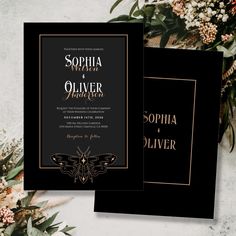 an elegant black and gold wedding card with flowers on the side, in front of a white background