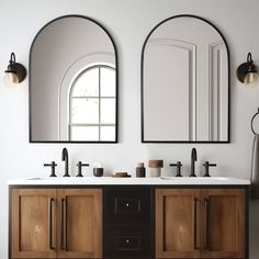 two mirrors are above the double sinks in this bathroom