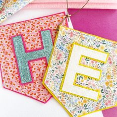 two handmade cards with the letters e and f on them, next to each other